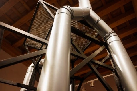 vertical-metal-pipes-inside-an-industrial-warehous-2023-11-27-05-30-47-utc-480x320